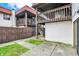Backyard featuring a wooden privacy fence, landscaping, and multi-level balconies at 8545 La Corrida Ct, Indianapolis, IN 46227