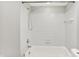 Bright bathroom featuring a shower-over-tub and white tiled walls at 8545 La Corrida Ct, Indianapolis, IN 46227