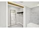 Modern bathroom closet with marble floors, mirror, and shelf with hanging rod at 8545 La Corrida Ct, Indianapolis, IN 46227
