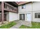 Exterior of home featuring a balcony, white stucco, tile roof, front door, and concrete patio at 8545 La Corrida Ct, Indianapolis, IN 46227