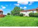 Exterior shot showing green grass, buildings, shrubs, and trees at 8545 La Corrida Ct, Indianapolis, IN 46227