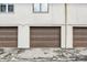 Garage doors with brown finish are beneath windows on exterior at 8545 La Corrida Ct, Indianapolis, IN 46227