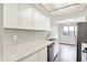 Bright kitchen featuring stainless steel appliances, white cabinets, and light marble countertops at 8545 La Corrida Ct, Indianapolis, IN 46227