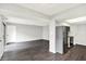Kitchen and living room area with vinyl floors, stainless steel appliances, and neutral paint at 8545 La Corrida Ct, Indianapolis, IN 46227