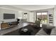 Spacious living room featuring modern decor, hardwood floors, and backyard patio access at 8545 La Corrida Ct, Indianapolis, IN 46227