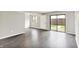 Bright living room with luxury vinyl floors, white trim, and sliding glass door to the backyard at 8545 La Corrida Ct, Indianapolis, IN 46227