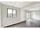 Bright living room with luxury vinyl floors, white trim, and windows overlooking backyard at 8545 La Corrida Ct, Indianapolis, IN 46227