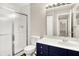 This bathroom has a shower, toilet, and a vanity with a white countertop and blue cabinets at 8720 Yardley Ct # 108, Indianapolis, IN 46268