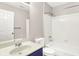 The bathroom features a shower-tub combination, toilet, and a white vanity with blue cabinets at 8720 Yardley Ct # 108, Indianapolis, IN 46268