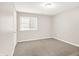 Bright, carpeted bedroom featuring a window and ample space at 8720 Yardley Ct # 108, Indianapolis, IN 46268