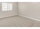 This bedroom features neutral walls, plush carpeting, and a window offering natural light at 8720 Yardley Ct # 108, Indianapolis, IN 46268