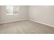 This bedroom has neutral walls, plush carpeting, and a window offering natural light at 8720 Yardley Ct # 108, Indianapolis, IN 46268