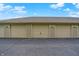 Row of garages with numbered doors beneath a blue sky with scattered clouds at 8720 Yardley Ct # 108, Indianapolis, IN 46268