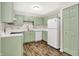 Charming kitchen with updated cabinets, modern appliances, and wood-look flooring at 8720 Yardley Ct # 108, Indianapolis, IN 46268