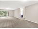 Bright living room features neutral walls, plush carpeting, and a sliding glass door to the outdoors at 8720 Yardley Ct # 108, Indianapolis, IN 46268