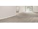This open living area boasts a sliding glass door and neutral decor, creating a comfortable space at 8720 Yardley Ct # 108, Indianapolis, IN 46268