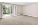 Spacious living room featuring neutral carpet and sliding glass doors to a patio at 8720 Yardley Ct # 108, Indianapolis, IN 46268