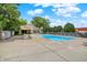 Community pool surrounded by trees and lounge chairs at 8720 Yardley Ct # 108, Indianapolis, IN 46268