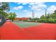 Outdoor tennis court with red surface and green playing area at 8720 Yardley Ct # 108, Indianapolis, IN 46268