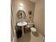 Compact bathroom with pedestal sink, toilet, and decorative touches at 902 N Bauman St, Indianapolis, IN 46214