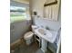 Bathroom featuring a pedestal sink and striped window valance at 902 N Bauman St, Indianapolis, IN 46214