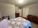 Bedroom with wood floors, double closets, and a comfortable bed at 902 N Bauman St, Indianapolis, IN 46214