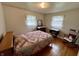 Charming bedroom featuring hardwood floors and vintage-style furnishings at 902 N Bauman St, Indianapolis, IN 46214