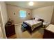 Cozy bedroom with hardwood floors and a comfortable quilt-covered bed at 902 N Bauman St, Indianapolis, IN 46214