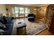 Cozy living room with hardwood floors, comfortable seating, and natural light from large windows at 902 N Bauman St, Indianapolis, IN 46214