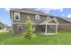 The home has a sprawling backyard, patio, brick exterior, and lush green grass at 928 Ridge Rock Ln, Bargersville, IN 46106
