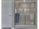 Elegant walk-in shower featuring a glass door, grey tiles and an adjustable showerhead at 928 Ridge Rock Ln, Bargersville, IN 46106