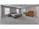 Bright bedroom with a wooden bed frame, neutral walls, carpet, and modern fixtures at 928 Ridge Rock Ln, Bargersville, IN 46106