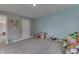 A bonus room with light blue walls and plush carpet is great for ' area or play space at 928 Ridge Rock Ln, Bargersville, IN 46106