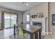 Bright dining area boasts a fireplace, sliding glass door, and stylish decor at 928 Ridge Rock Ln, Bargersville, IN 46106