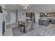 Stylish kitchen with dark cabinets, stainless appliances, and a wooden dining table at 928 Ridge Rock Ln, Bargersville, IN 46106