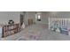 A versatile, carpeted loft space with doorway views and a play area with a colorful rug at 928 Ridge Rock Ln, Bargersville, IN 46106