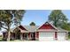 Craftsman-style home featuring a red exterior, stone accents, and a spacious three-car garage at 0 Whitetail Ridge Lot 3, Mooresville, IN 46158