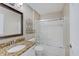 Bathroom with granite vanity, framed mirror, and white tile shower with sliding glass door at 1074 Timber Creek Dr # 8, Carmel, IN 46032