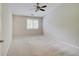 Neutral bedroom with a ceiling fan and a view of the outdoor area at 1074 Timber Creek Dr # 8, Carmel, IN 46032