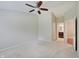 Neutral bedroom with a ceiling fan and doorway to an attached bathroom at 1074 Timber Creek Dr # 8, Carmel, IN 46032