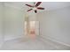 Neutral bedroom with a ceiling fan and doorway to an attached room at 1074 Timber Creek Dr # 8, Carmel, IN 46032