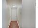 Hallway featuring hardwood floors, with a white door at the end and neutral-colored walls at 1074 Timber Creek Dr # 8, Carmel, IN 46032