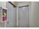 Hallway featuring two gray doors, one with a fire extinguisher, and a neutral color scheme at 1074 Timber Creek Dr # 8, Carmel, IN 46032