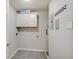 Functional laundry room with tile floors, storage cabinet, and utility connections at 1074 Timber Creek Dr # 8, Carmel, IN 46032