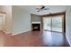 Bright living room featuring a fireplace, sliding glass doors to a balcony, hardwood flooring, and neutral paint at 1074 Timber Creek Dr # 8, Carmel, IN 46032