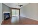 Spacious living room with a fireplace, vaulted ceiling, hardwood flooring, and sliding glass doors to a balcony at 1074 Timber Creek Dr # 8, Carmel, IN 46032