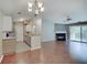 Open-concept living space connecting the kitchen, dining area, and living room with fireplace and balcony access at 1074 Timber Creek Dr # 8, Carmel, IN 46032