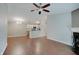 Open living space with hardwood floors, a fireplace, chandelier, and a view of the kitchen with modern cabinets at 1074 Timber Creek Dr # 8, Carmel, IN 46032