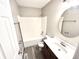 Well-lit bathroom featuring a vanity with storage, an oval mirror, and a tub-shower combination at 10922 Snowdrop Way, Indianapolis, IN 46235