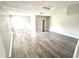 Bright bedroom featuring wood-look flooring, fresh paint, and a sunny window at 10922 Snowdrop Way, Indianapolis, IN 46235